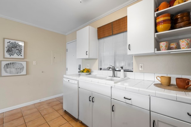 kitchen featuring white dishwasher, sink, crown molding, tile counters, and white cabinetry