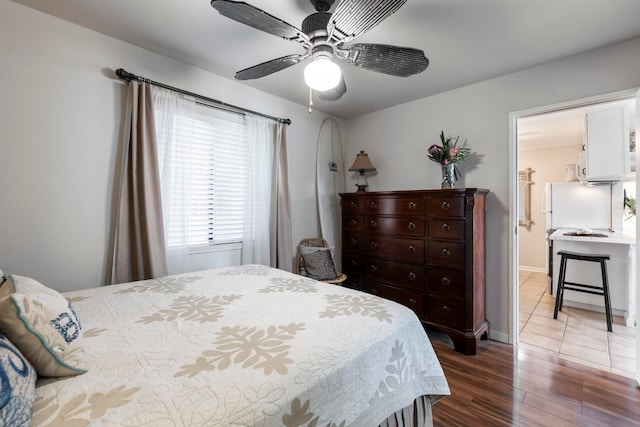 bedroom with ceiling fan and hardwood / wood-style flooring