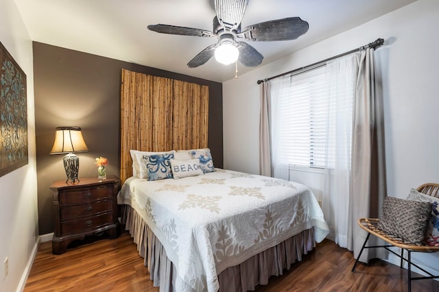 bedroom with ceiling fan and dark hardwood / wood-style flooring