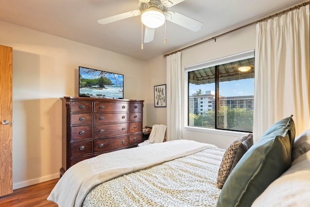 bedroom with ceiling fan and hardwood / wood-style flooring