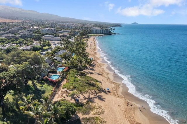 drone / aerial view featuring a water and mountain view and a view of the beach