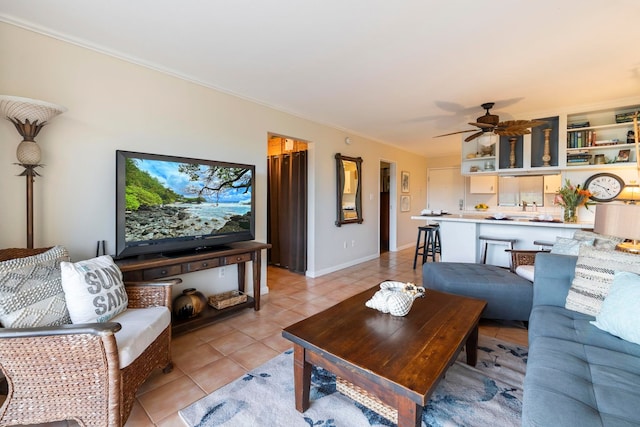 living room featuring light tile patterned floors, ceiling fan, and ornamental molding