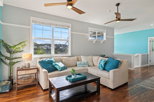 living area with ceiling fan and dark wood-type flooring