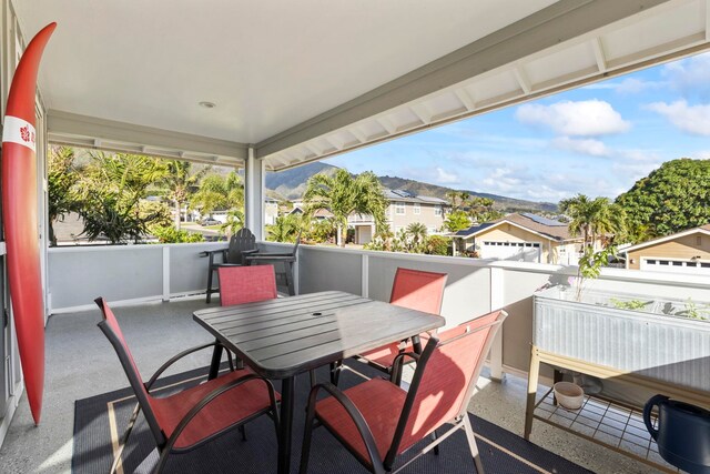 balcony featuring a mountain view, a sunroom, and a residential view