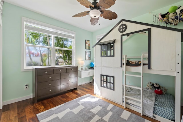 bedroom with dark wood-style flooring and baseboards