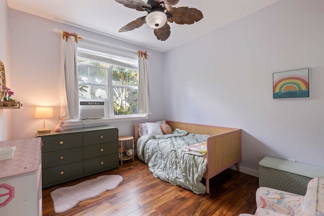 bedroom with dark wood-style floors, ceiling fan, baseboards, and cooling unit