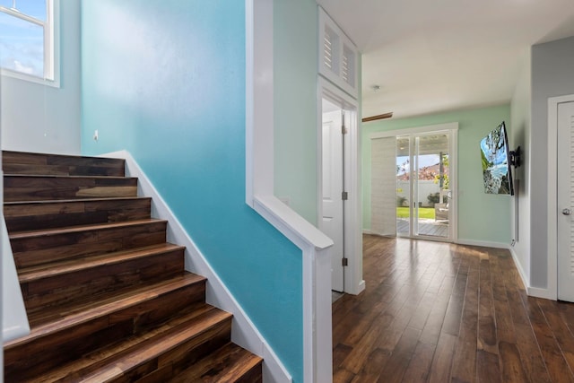 stairs with baseboards and wood finished floors