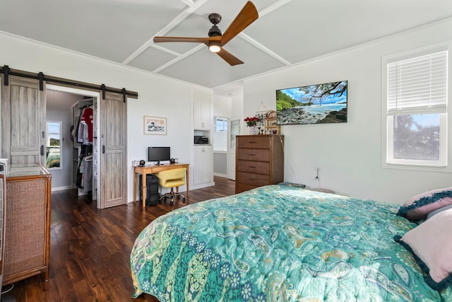 bedroom with a barn door, baseboards, ceiling fan, dark wood-style flooring, and a spacious closet