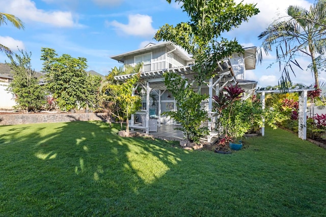 back of house featuring board and batten siding, a pergola, and a yard