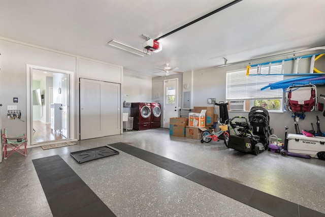 garage featuring separate washer and dryer, electric panel, and a garage door opener