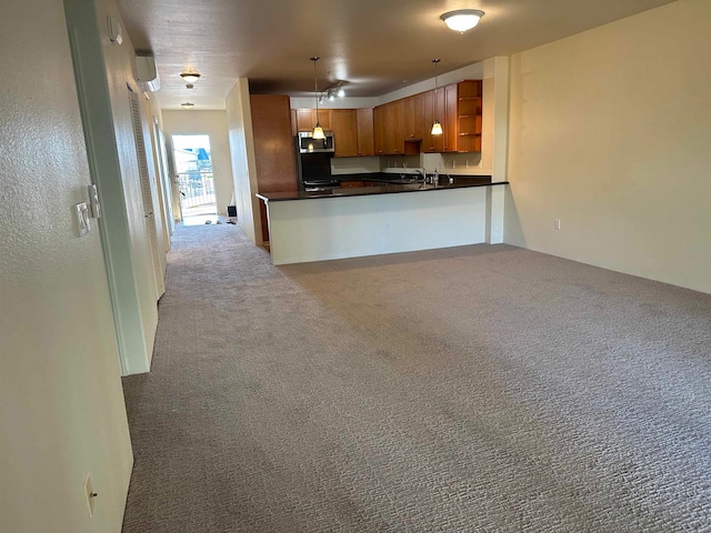 kitchen featuring pendant lighting, sink, kitchen peninsula, and light carpet