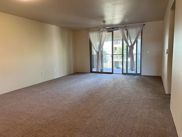 empty room featuring carpet flooring and ceiling fan