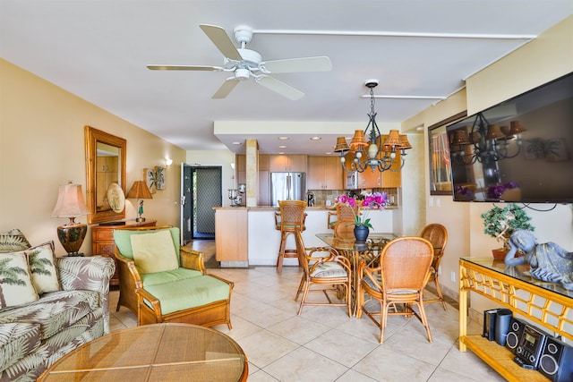 dining space featuring ceiling fan with notable chandelier and light tile patterned floors