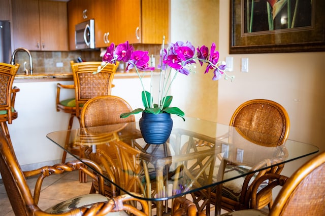 tiled dining area featuring sink