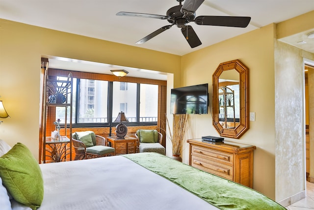 tiled bedroom featuring ceiling fan