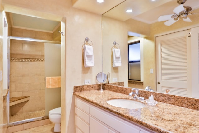 bathroom with tile patterned floors, toilet, vanity, an enclosed shower, and ceiling fan