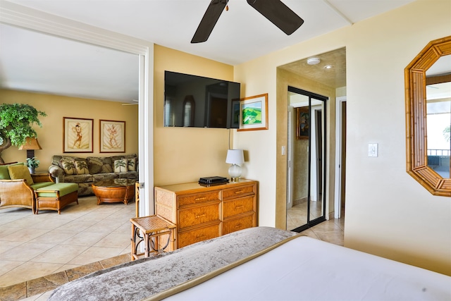 bedroom featuring a closet, light tile patterned floors, and ceiling fan