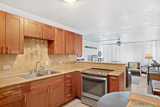 111 Kahului Beach Rd Unit D306, Kahului, HI 96732 - kitchen featuring stainless steel electric range oven, a sink, light tile patterned floors, a peninsula, and light countertops