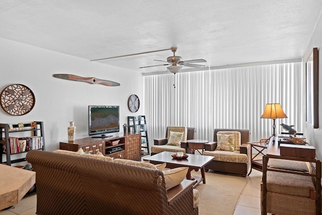 111 Kahului Beach Rd Unit D306, Kahului, HI 96732 - living room with light tile patterned floors, ceiling fan, and a textured ceiling