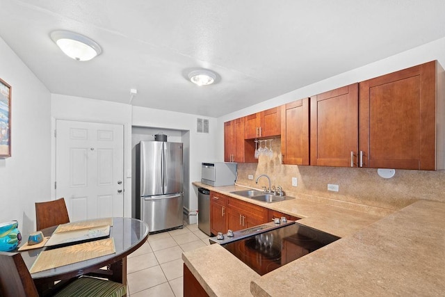 111 Kahului Beach Rd Unit D306, Kahului, HI 96732 - kitchen with appliances with stainless steel finishes, a sink, decorative backsplash, light countertops, and light tile patterned floors