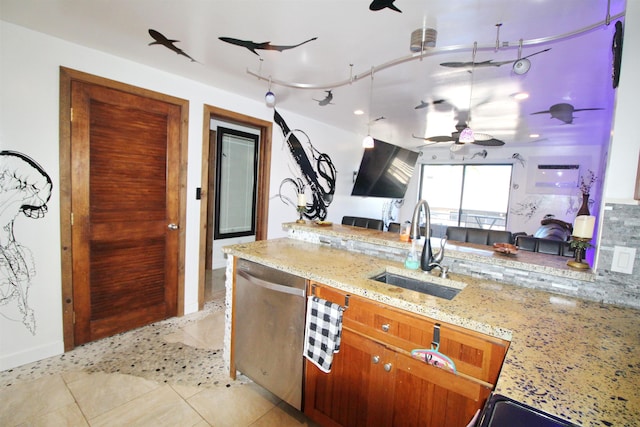 kitchen with sink, light tile patterned floors, dishwasher, ceiling fan, and light stone countertops