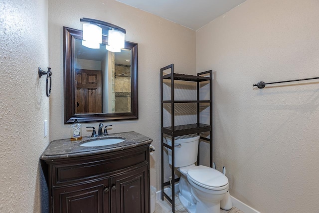 2747 S Kihei Rd Unit H208, Kihei, HI 96753 - bathroom with toilet, vanity, baseboards, and a textured wall