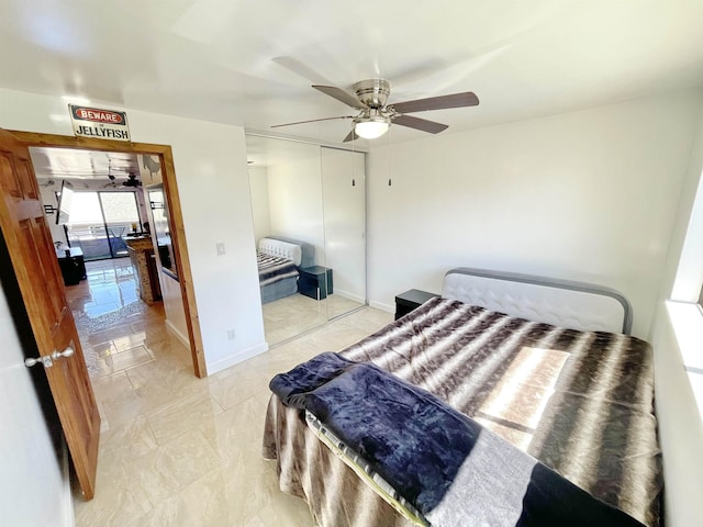 bedroom with ceiling fan and a closet