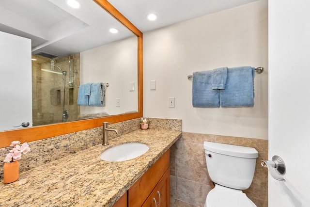 bathroom featuring toilet, vanity with extensive cabinet space, tile flooring, and an enclosed shower