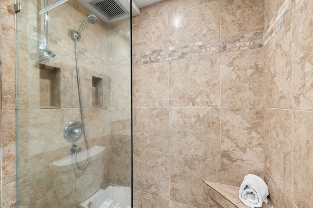 bathroom with tiled shower