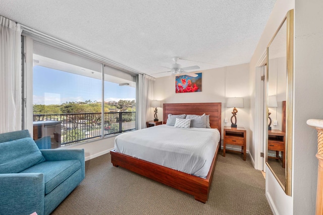 carpeted bedroom featuring a textured ceiling and ceiling fan