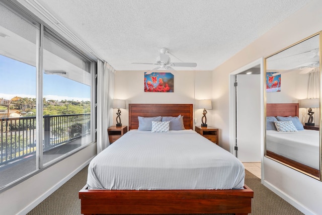 bedroom with light colored carpet, ceiling fan, and a textured ceiling