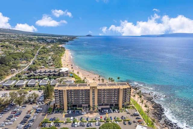 birds eye view of property featuring a beach view and a water view