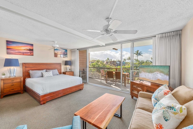 bedroom with expansive windows, access to exterior, ceiling fan, a textured ceiling, and carpet flooring