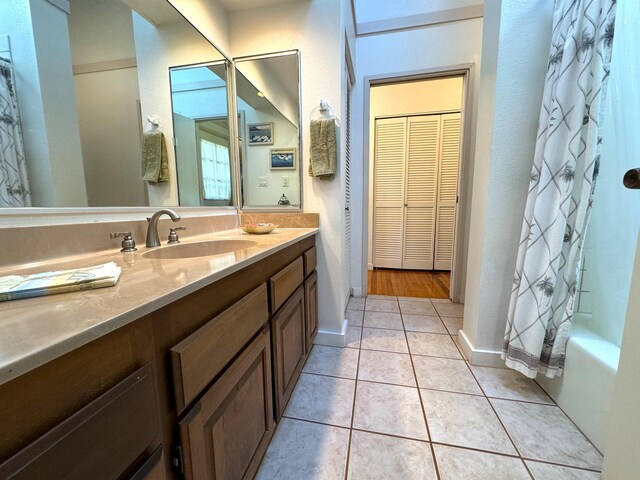 bathroom with tile floors and vanity