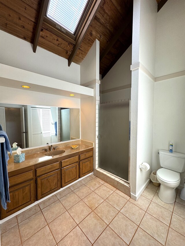 bathroom featuring vanity, tile floors, lofted ceiling with skylight, wooden ceiling, and toilet