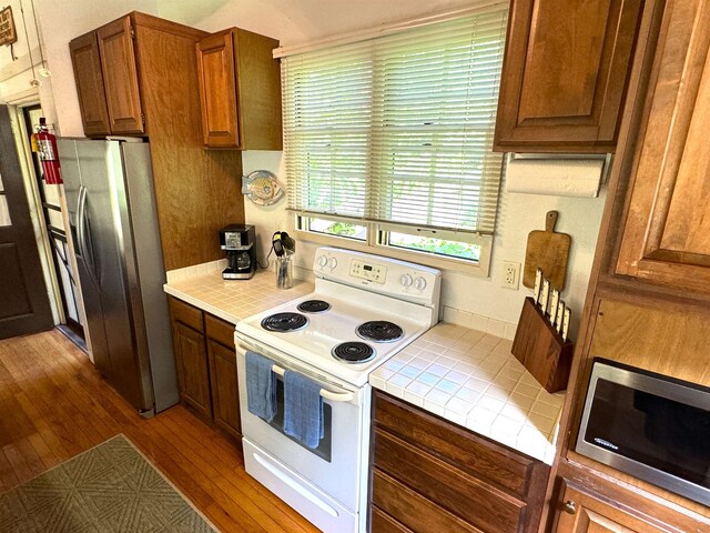 kitchen featuring dark hardwood / wood-style flooring and appliances with stainless steel finishes