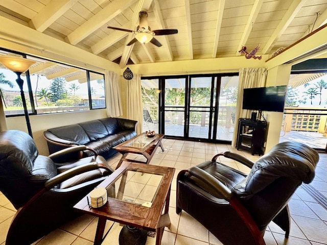 tiled living room featuring plenty of natural light, lofted ceiling with beams, and ceiling fan