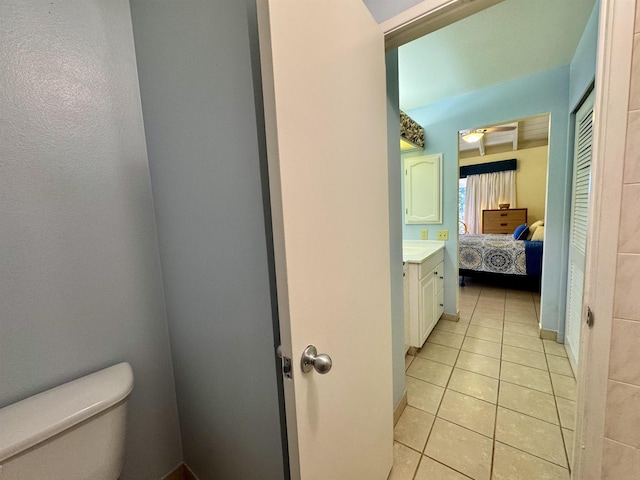 bathroom with vanity, tile patterned floors, and toilet