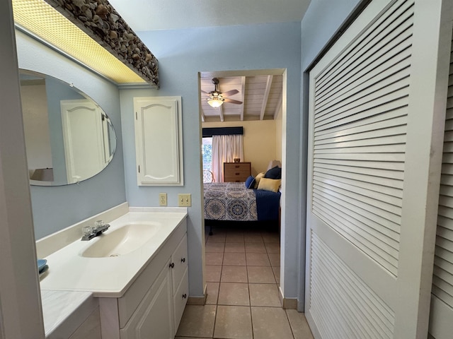 bathroom with lofted ceiling, vanity, tile patterned floors, and ceiling fan