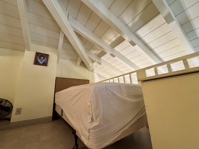 bedroom with vaulted ceiling with beams and wooden ceiling