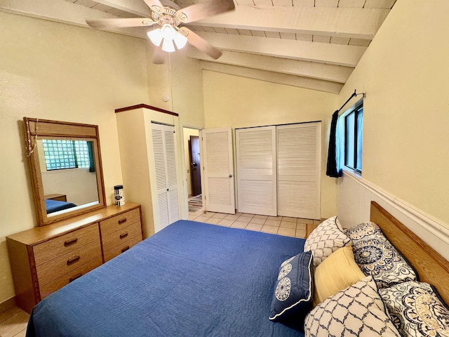 bedroom featuring lofted ceiling with beams, light tile patterned floors, wood ceiling, and ceiling fan