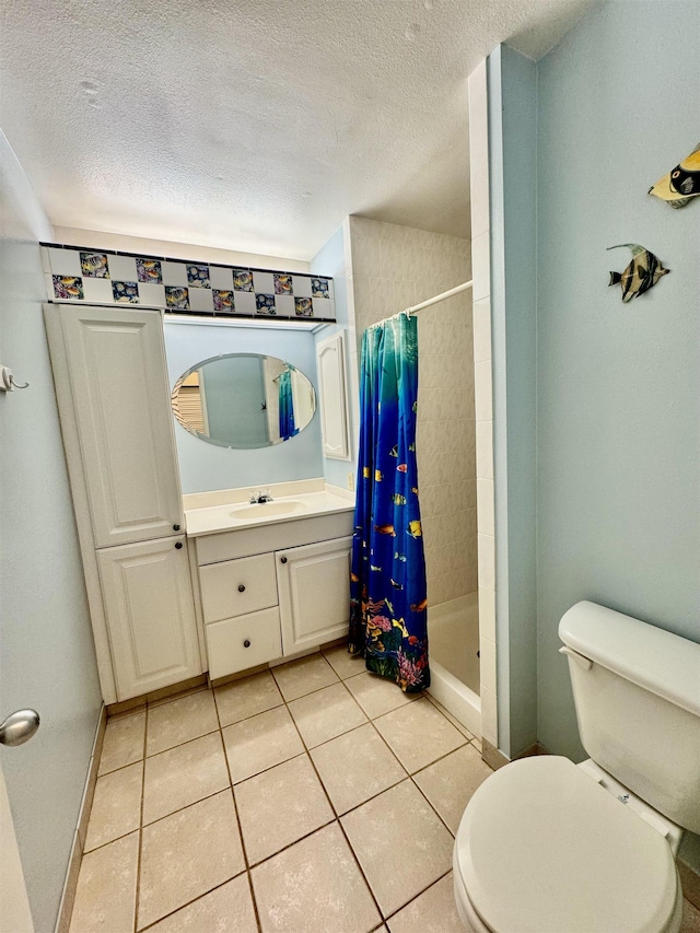 bathroom with tile patterned flooring, vanity, walk in shower, toilet, and a textured ceiling