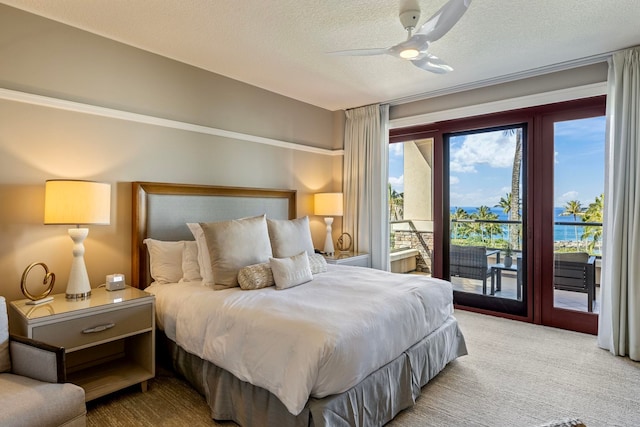 bedroom featuring access to exterior, a textured ceiling, carpet, and a ceiling fan