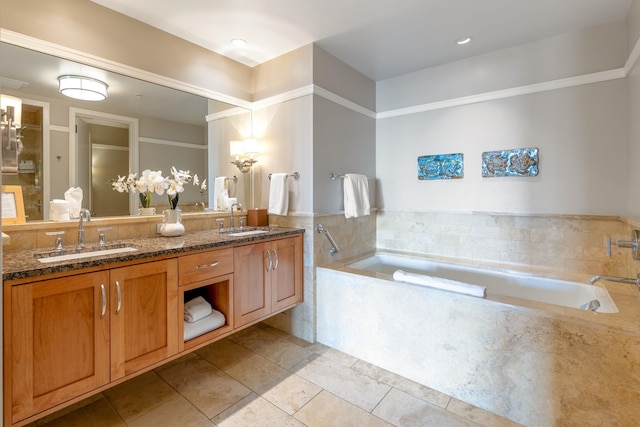 bathroom with double vanity, a bath, tile patterned floors, and a sink