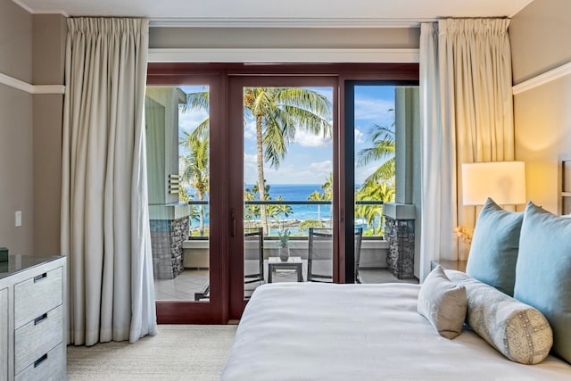 bedroom with a water view and carpet