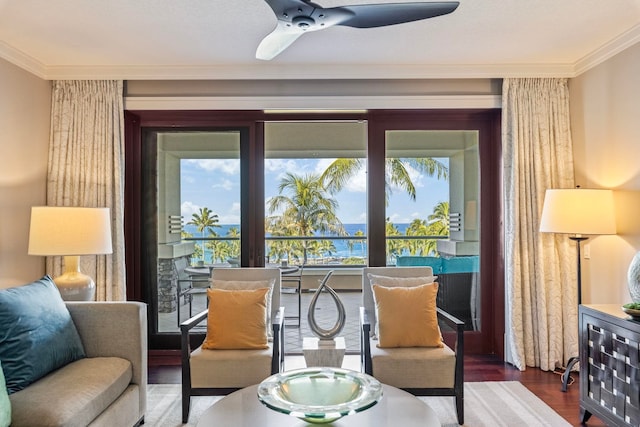 living area featuring ceiling fan, wood finished floors, and ornamental molding