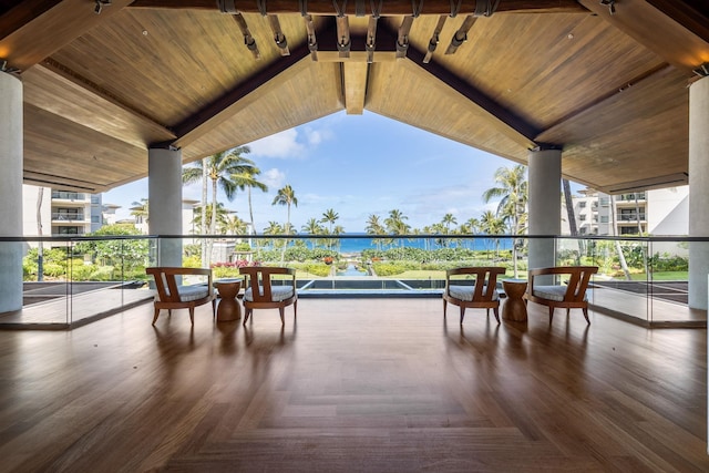 view of patio featuring a balcony and a water view