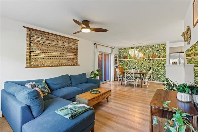 living room featuring hardwood / wood-style floors and ceiling fan with notable chandelier