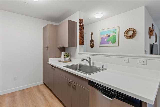 56 Kihalani St Unit 1203, Kihei, HI 96753 - kitchen with stainless steel dishwasher, a sink, light wood-type flooring, light countertops, and baseboards
