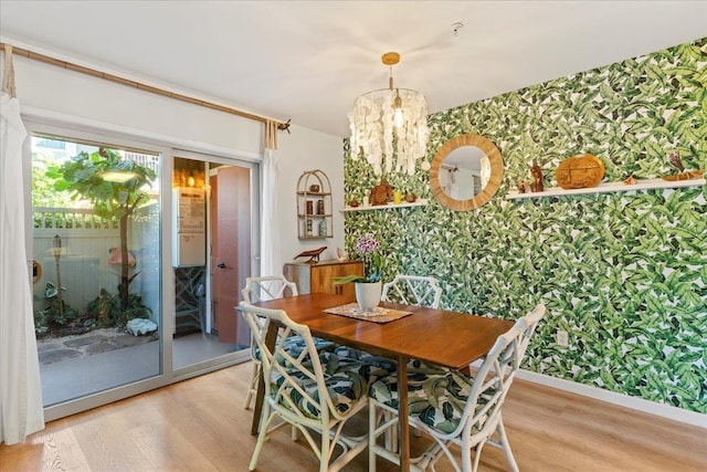 56 Kihalani St Unit 1203, Kihei, HI 96753 - dining area with wallpapered walls, light wood-style flooring, a chandelier, and baseboards